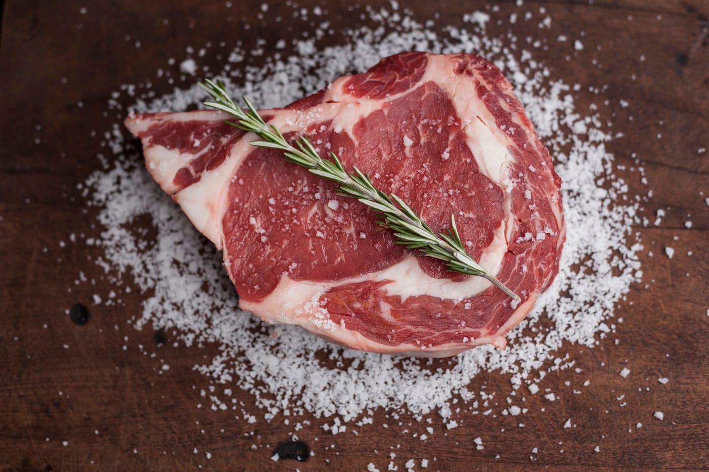 Raw beef ribeye on a butcher's block
